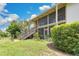 A condominium building with stairway access to screened in patios and manicured lawns at 200 Maitland Ave # 122, Altamonte Springs, FL 32701