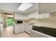 Functional kitchen featuring white cabinetry, modern appliances, and tile floors at 200 Maitland Ave # 122, Altamonte Springs, FL 32701