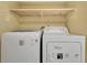 Laundry room with stacked washer and dryer and custom shelving at 200 Maitland Ave # 122, Altamonte Springs, FL 32701