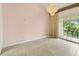 Vaulted living room featuring tile floors, a view of the exterior and a chandelier at 200 Maitland Ave # 122, Altamonte Springs, FL 32701