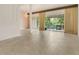 Spacious living room featuring tile floors, large windows, and a decorative chandelier at 200 Maitland Ave # 122, Altamonte Springs, FL 32701