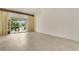 Minimalist living room showcasing tile floors and a sliding door for natural lighting at 200 Maitland Ave # 122, Altamonte Springs, FL 32701