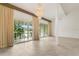 Bright living room showcasing tile floors, a chandelier, and views from the sliding glass doors at 200 Maitland Ave # 122, Altamonte Springs, FL 32701