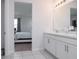 Bathroom with a double sink vanity and an adjoining bedroom at 200 Summershore Dr, Auburndale, FL 33823