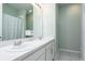 Bathroom boasting a double sink vanity, white cabinets and light green walls and a shower/bath combo at 200 Summershore Dr, Auburndale, FL 33823