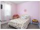 A delightful bedroom featuring pink walls and a playful floral-themed bedspread at 200 Summershore Dr, Auburndale, FL 33823