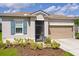 Close-up of house front exterior showcasing a well-maintained lawn and partial driveway at 200 Summershore Dr, Auburndale, FL 33823