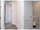 Hallway with white walls and wood floors with access to the laundry room at 200 Summershore Dr, Auburndale, FL 33823
