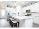 Bright kitchen featuring a large center island with seating, stainless steel appliances, and modern finishes at 200 Summershore Dr, Auburndale, FL 33823