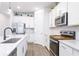 Well-lit kitchen featuring a large center island, stainless steel appliances, and elegant countertops at 200 Summershore Dr, Auburndale, FL 33823
