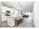 Modern kitchen featuring white cabinetry, a center island with seating, and stainless steel appliances at 200 Summershore Dr, Auburndale, FL 33823