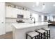 Contemporary kitchen with white cabinets, a center island with seating, and stainless steel appliances at 200 Summershore Dr, Auburndale, FL 33823