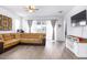 Bright living room with a large sectional, light wood floors, and sliding glass doors to the backyard at 200 Summershore Dr, Auburndale, FL 33823