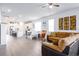 Open concept living room and kitchen with stainless appliances and light wood flooring at 200 Summershore Dr, Auburndale, FL 33823