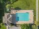 Aerial view of the pool with clear blue water, outdoor shower, and lounge chairs at 200 Summershore Dr, Auburndale, FL 33823