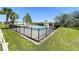 Fenced in community pool with an outdoor restroom and clear blue skies at 200 Summershore Dr, Auburndale, FL 33823