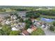 A vibrant aerial view of a residential neighborhood with tree-lined streets and a serene pond at 202 Twisting Trl, Orlando, FL 32825