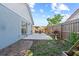 Backyard features a patio with outdoor seating, lawn area, and wood fence at 202 Twisting Trl, Orlando, FL 32825