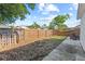 Fenced backyard features a sparse lawn with patio, partial landscaping, and wood privacy fence at 202 Twisting Trl, Orlando, FL 32825