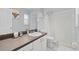 Well-lit bathroom featuring a vanity with sink, toilet, and shower with white tile surround at 202 Twisting Trl, Orlando, FL 32825