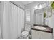 Bright bathroom with a shower/tub combination, toilet, and a vanity with a sink at 202 Twisting Trl, Orlando, FL 32825