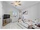 Bright bedroom with tile flooring, ceiling fan, and a large window with blinds at 202 Twisting Trl, Orlando, FL 32825