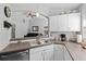 Gourmet kitchen with open concept to the living room featuring stainless appliances and modern lighting at 202 Twisting Trl, Orlando, FL 32825