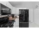 Modern kitchen featuring stainless steel appliances, white cabinetry, and tiled floors at 202 Twisting Trl, Orlando, FL 32825