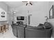 View of open living room featuring tile flooring, modern ceiling fan, and comfortable leather sofa at 202 Twisting Trl, Orlando, FL 32825