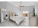 Bright primary bedroom featuring tiled floors, ceiling fan, and a large bed and sliding door access to the yard at 202 Twisting Trl, Orlando, FL 32825