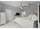 Vaulted ceiling bedroom with white tile flooring, ceiling fan and sliding glass door at 202 Twisting Trl, Orlando, FL 32825