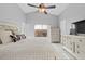 Bright main bedroom with a ceiling fan, sliding glass doors, and tiled flooring at 202 Twisting Trl, Orlando, FL 32825