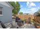 A patio with seating area features a kayak and partially fenced yard in the background at 202 Twisting Trl, Orlando, FL 32825