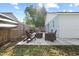 Patio area with seating, and landscaping beyond wood privacy fence at 202 Twisting Trl, Orlando, FL 32825
