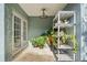 Outdoor patio with ceiling fan, french doors, and shelving with an abundance of potted plants at 202 Twisting Trl, Orlando, FL 32825