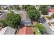 Aerial view of home's backyard with a small patio, grass, and privacy fence at 202 Twisting Trl, Orlando, FL 32825