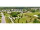 Aerial view of a community with a park area featuring a walking trail and a soccer field at 20330 Majestic St, Orlando, FL 32833