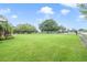 Large backyard featuring a manicured lawn and mature landscaping, offering privacy at 20330 Majestic St, Orlando, FL 32833