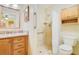 Well-lit bathroom featuring granite countertop, wood cabinets, and a tiled shower at 20330 Majestic St, Orlando, FL 32833