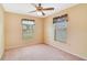 Bright bedroom with neutral walls, carpet, a ceiling fan, and natural light from two windows at 20330 Majestic St, Orlando, FL 32833