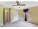 Bedroom with neutral walls, carpet, a ceiling fan, and a closet for ample storage at 20330 Majestic St, Orlando, FL 32833