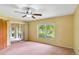Bright bedroom with a sliding glass door, large window, and neutral carpeting at 20330 Majestic St, Orlando, FL 32833