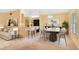 Dining area featuring modern lighting, neutral tones, and a view into the adjacent kitchen space at 20330 Majestic St, Orlando, FL 32833