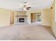 Spacious living room with a cozy stone fireplace, neutral carpeting, and a ceiling fan at 20330 Majestic St, Orlando, FL 32833