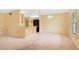 Large living room area featuring open access to kitchen area with breakfast bar and neutral carpeting at 20330 Majestic St, Orlando, FL 32833