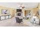 Spacious living room with a stone fireplace, ceiling fan, and neutral-toned walls and carpeting at 20330 Majestic St, Orlando, FL 32833