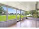 Enclosed patio with tile flooring, offering serene views of the lush backyard at 20330 Majestic St, Orlando, FL 32833