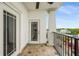 Balcony with tile flooring, black metal railing, and a column with ceiling fan at 2305 Edgewater Dr # 1509, Orlando, FL 32804