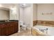 Bathroom with tub, tile surround, and vanity with dark cabinets and granite countertop at 2305 Edgewater Dr # 1509, Orlando, FL 32804