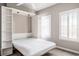 Bright bedroom featuring a Murphy bed, built-in shelving, and shuttered windows at 2305 Edgewater Dr # 1509, Orlando, FL 32804